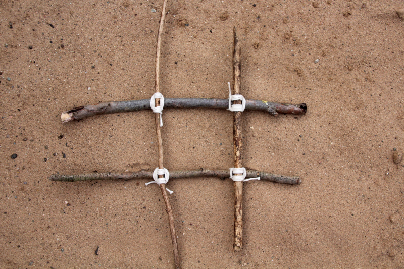 four sticks tied together to make a game grid